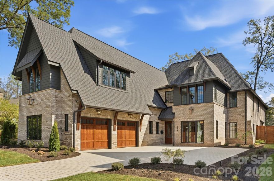 Welcome to 154 N Canterbury Rd, a showstopping luxury estate by Maverick Building that seamlessly blends elevated design, thoughtful functionality, and resort-style living in the heart of Cotswold. This exceptional 6 bedroom, 7.5 bath new construction home was designed for both everyday comfort and unforgettable entertaining. The outdoor living experience is truly unmatched, featuring a stunning pool and hot tub, a fully equipped pool cabana with a kitchen and oversized island, a full outdoor bath with changing area, and an outdoor shower. Three covered porches surround the pool, creating a private oasis complemented by expansive yard space ideal for recreation or relaxation surrounding the outdoor living spaces. Inside, the home continues to impress with curated designer finishes and refined architectural details throughout. The grand living room showcases 11-foot ceilings with exposed wood beams and a striking cast stone fireplace, while the walk-in wine room is complete with a steel frame entry door and custom cabinetry which provides a sophisticated focal point for entertaining. The primary suite is a true retreat, designed to feel like a luxury resort. Enjoy a private covered terrace looking at the pool, a spacious sitting area, and a custom coffee and wine bar. This primary suite also features a large walk-in shower, a soaking tub and an extraordinary custom closet with inset lighting, glass front cabinetry, soft close drawers, and a Taj Mahal quartzite waterfall island. A junior primary suite on the main level offers the perfect private space for guests, complete with a soaking tub and dual vanities. Upstairs, the bonus room provides incredible flexibility with built in seating, a large open layout, wet bar, and full bath that makes it ideal for a media room, lounge, or guest retreat. Every inch of this home reflects intentional design. The lighting, custom cabinetry, flooring, color palette, and wallpaper selections creating a cohesive and elevated aesthetic throughout. Situated on one of Cotswold’s most sought after and walkable streets, surrounded by high-end new construction and estate homes, this prime location offers convenient access to SouthPark, Uptown, private schools, shopping, dining, and everything that makes this area so desirable.