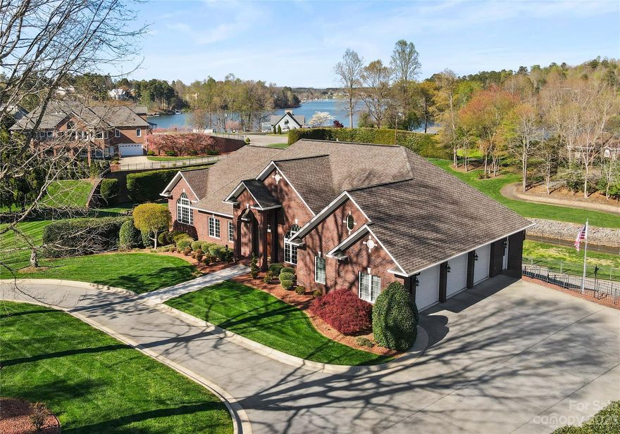 Solidly built and meticulously maintained, this 7,000 SF waterfront home on Lake Hickory offers three bedrooms and a lower level in-law suite with private garage entrance and full kitchen! The main level features a soaring 14' tall foyer opening onto a formal dining room, with a columned entrance to the great room overlooking the lake. The spacious kitchen offers a center island, plenty of cabinet storage, a bayed breakfast area, and hallway to the laundry, half bath, and triple garage. The main level also features relaxing primary suite with private bath and walk-in closet, plus a 2nd bedroom suite with private bath and a study. The upper level features a huge bonus room, craft room, & office. The full lower level can double as an in-law suite, featuring a den, bedroom, two full baths, full kitchen, gym, billiards area, sunroom, storage/workshop, and garage area.  Outside, enjoy the 1.73 acre double lot with in-ground pool, fire pit, covered dock, and long-range views of Lake Hickory.