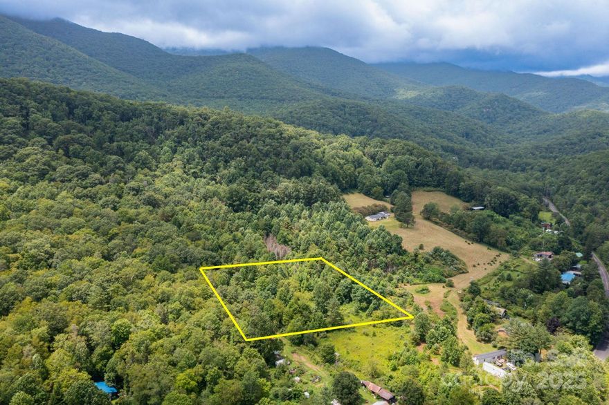 Discover the possibilities with this 2.08-acre undeveloped parcel offering a rare blend of flat, usable land and natural mountain beauty. Located just off Rock Creek Road—minutes from the South Toe River—this property enjoys a road right-of-way for easy access and two valuable water sources, including a water right-of-way from an active spring that flows across the rear of the land. Enjoy seasonal mountain views in the winter and the peaceful setting year-round. Outdoor enthusiasts will love the proximity to camping, fishing, hiking, and swimming along the South Toe River, as well as nearby attractions like Mount Mitchell, Roaring Fork Falls, and Mount Mitchell Golf Club (temporarily closed). Whether you envision a private retreat, vacation getaway, or investment opportunity, this flat, well-situated property offers the perfect foundation for your mountain dream. NO DRIVE-BYS - APPOINTMENT REQUIRED