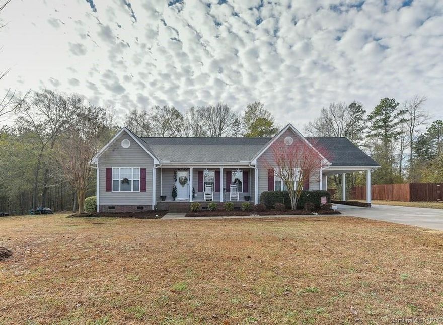 Lovely beautifully maintained 3 br 2 ba home in popular Hunters Ridge.  This one has SO much to offer!  Positioned in subdivision so that no construction will occur behind home, leaving beautiful peaceful undeveloped view from newly extended back deck.  Established yard with maturing trees and shrubs.  Recently added durable great looking wide plank dark laminate wood flooring, gutters, new dishwasher, new disposal, redesigned laundry and master closet. Beautiful yard with oaks, maple, and crepe myrtles that will continue to grow.  Extended flower and shrub beds. Much of home is recently painted in popular grays.  Beautiful welcoming den.  Charming white kitchen with lots of counter and cabinet space.  Laundry conveniently located off kitchen.  Split modified open floor plan.  Very large master easily accommodates king bed.  Second and third bedrooms are roomier than most in subdivision.  Large flat half acre lot, great for play, pets. Everything about this house will say home.