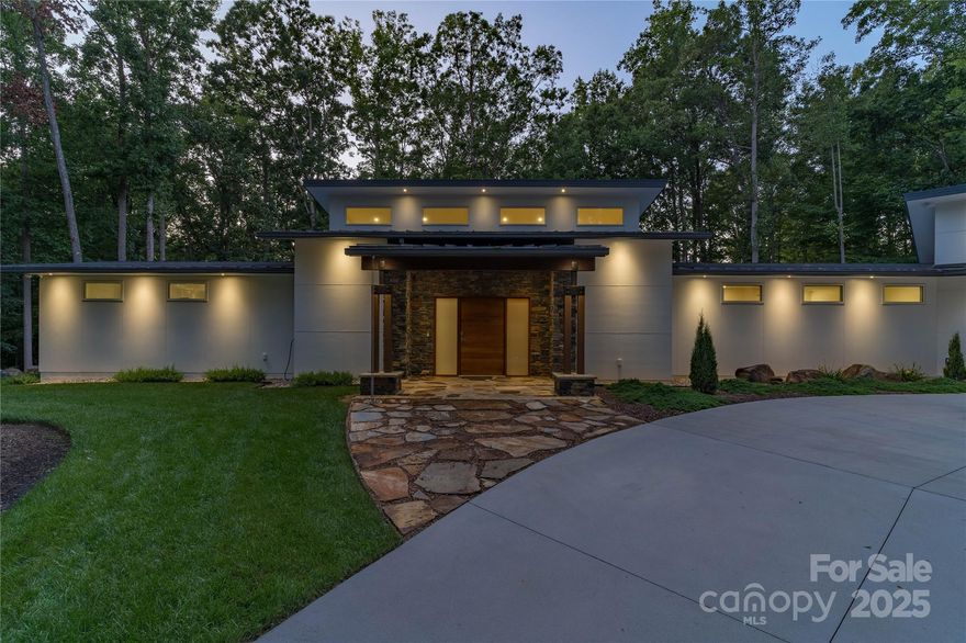 This property boasts impressive features, including three bedrooms and two bathrooms, situated on 1.5 acres of land. Built in 2020, the residence showcases SIP construction with a concrete base, utilizing fiber-reinforced concrete to eliminate cracks. Additional highlights include a tin roof with a 40-year warranty, LED high hats throughout, engineered bamboo flooring, and handicapped accessibility. An automated irrigation system further enhances the property's appeal. Externally, the house is complemented by rock walls, a comprehensive security camera system providing 360-degree coverage, and a 22 KVA generator. The backyard features a covered patio with stone flooring, ceiling fans, and lighting, alongside a fire pit surrounded by flagstones and river rock pebbles, and landscaped with diverse plants and boulders. The landscape includes fescue grass, junipers, Thuja Green Giant trees, mulch, river rocks, and boulders, with mature trees adding to the ambiance. The cemented driveway is equipped with LED lights and drainage systems lined with rocks. Upon entering, residents and guests are greeted by a black walnut solid wood pivot door, flagstone and river rock pebble flooring, and stoned pillars. Internally, the house boasts LED high hats, bamboo engineered flooring, an open floor plan with high ceilings, and premium finishes including large wooden cabinets, quartz countertops, and a gas fireplace. The master suite features its own AC system, custom-designed closets, and remote control window shades, while the master bath includes a walk-in shower and heated floor. Guest bedrooms offer custom-made decorations and window treatments. Additional amenities include a family room, guest bathroom, laundry room, and a spacious 3-car garage with epoxy flooring and car lift connections.