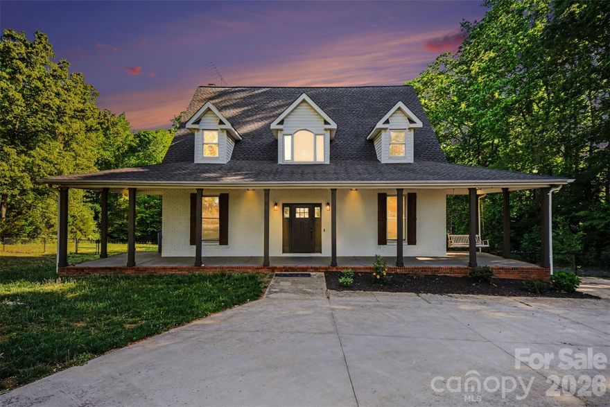 Come check out this beautiful modern home on 1.4 private acres with NO HOA that is just minutes to Lake Wylie and a quick commute to Charlotte. Open-concept layout with a huge two-story foyer and great room, plus hardwoods throughout the main level. The upgraded kitchen features granite counter tops, custom backsplash, stainless steel appliances, pull-out shelving, and dual lazy Susans. Main-level primary suite features dual vanities, custom tile, garden tub, and a large walk-in shower. Spacious bedrooms and abundant storage throughout.
A fully finished basement adds flexible living space. The rear-entry garage and automated driveway gate enhance privacy. The spacious fenced in backyard backs up to a large wooded area, with a wraparound front porch and expansive rear deck this home is perfect for entertaining. Major bonus: roof replaced in 2019.