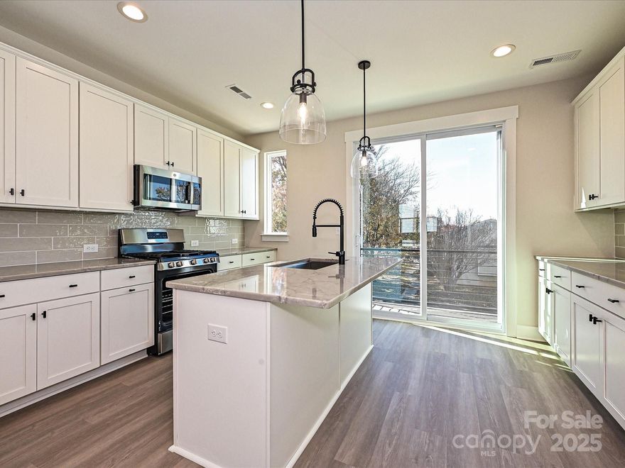 Have it all with this Camp North End-area townhome. 4 floors include a 1st floor flex rm w/ powder, terrace off the kitchen w/ seasonal city skyline views, & a nice sized 4th floor rooftop terrace & rec rm w/ powder. Abundant space for entertaining, guests, or home office. Also included is a 1-car garage & driveway.  Kitchen features 42" cabs, matte black hardware, trash pullout, large undermount stainless sink, quartz counters, and GE stainless steel appliances with a gas range. It leads to the open dining/living area. 3rd floor has a laundry closet and a hall bath. Full baths include matte black hardware, quartz counters, and tiled floors, with a tiled shower in the Premier Bath with semi-frameless glass. LVP is throughout the 1st & 2nd floor plus 3rd floor hall, with tile in full and half baths, and oak treads on all stairs. 9' ceilings throughout. Uptown Charlotte is just minutes away!