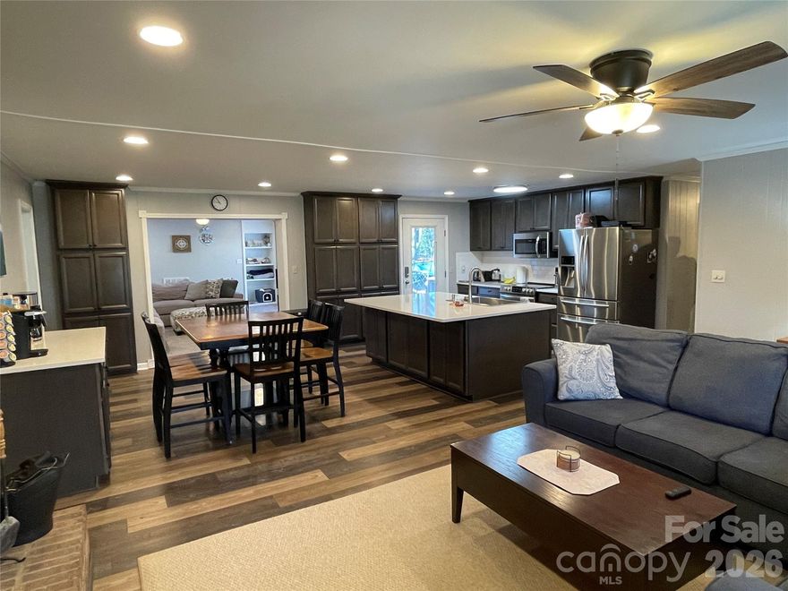 Located in an established neighborhood where you can take a stroll around the nearby small lake, this home is fresh and move-in ready, blending modern updates with functional space. Step through the front door to, “Wow.” This meticulously transformed beauty evolved from a standard ranch with only a carport into a spacious 4-bedroom, 3-bathroom retreat with an enclosed garage and dual primary suites. Updates includes a massive 764 sq. ft. addition (2009) featuring a family room and primary suite with walk-in closet, garden tub, and double-head shower. Other major upgrades (2021): Brand new kitchen (from the joists up!), new roof, and dual HVAC systems. New water heater (2026). Open concept living with a seamless flow between the kitchen, dining, and living room, anchored by a cozy wood-burning fireplace, and into the family room addition. Relax on the rocking chair front porch or head to the back deck to enjoy the above-ground pool (new liner 2024). Pool is open and ready for summertime just around the corner. Plenty of parking for your friends with the double-width concrete driveway plus a gravel pad for an RV, boat, or trailer. Enclosed garage features a 7x7 dedicated workshop area at the rear. Owners relocated the washer and dryer to the garage, converting the original laundry room to a "drop zone" with desk. Hidden interior hook-ups remain, so easily reverts back to indoor laundry if preferred. Backyard storage building plus a pull-down staircase to a partially floored attic. All appliances, including the refrigerator, washer, and dryer, are included in the sale. Peace of mind of an enclosed crawl space with app monitored dehumidifier. Come tour and imagine your next get together entertaining in the open floor plan, lounging on the deck, or splashing in the glimmering pool.