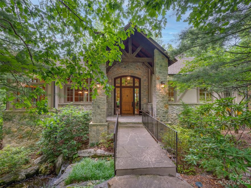 Spectacular home with gorgeous views of the Blue Ridge Mountains and sunsets! Quality construction, beautiful details, spacious rooms yet the perfect size at 4209. Step across the bridge, that leads to the main entrance. You're greeted by views and soaring coffered ceiling, limestone fireplace and wall of windows. The great room is open to the dining area which is steps away from the chef’s kitchen with beautiful alder cabinetry, flamed granite, and high-end appliances. Off the dining area is a fabulous 3 season room with stone fireplace, wood ceiling, grill and exhaust hood. Completing the main level is the lovely primary suite. Lower level has a family room with built-ins and access to the open deck, plus 2 guest suites and wine cellar/tasting room. There is a generator, elevator, hot water heat in family room floor, lush landscaping and great privacy. Home to Tom Fazio’s amazing Mountain Masterpiece golf course. SELLER PREFERS TO SELL TO GOLFER WHO BUYS A FULL EQUITY MEMBERSHIP.