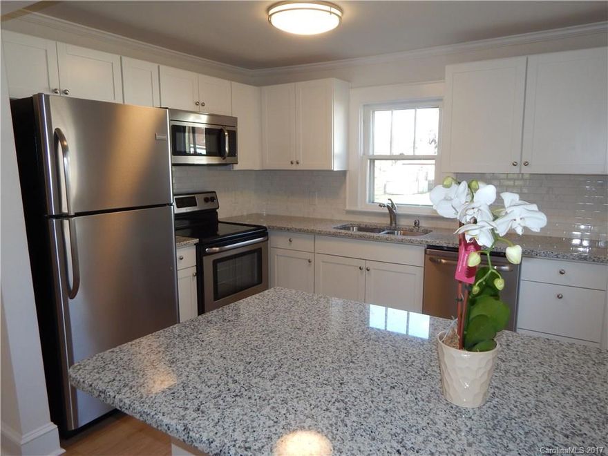 Totally rehabed & like new including plumbing, electrical, flooring, kitchen, & bath.White kitchen with stainless steel appliances,granite counters,tile backsplash,peninsula w breakfast bar.Microwave.Dishwasher. Self cleaning oven.Cathedral type ceilings in living room.New hardwood floors in living room,sitting room & kitchen.New carpet in bedrooms.New gorgeous bath with tile flooring.Sitting room addition with hookups for washer & dryer and attic space.Original glass door knobs.