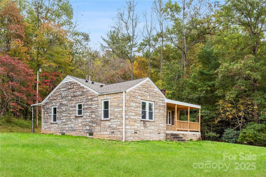 Discover peaceful country living in this beautifully updated 3-bedroom, 2-bath home set on over an acre in the heart of Marshall, NC. This move-in ready property blends modern updates with rustic charm, featuring new flooring throughout, a completely refreshed kitchen with ample cabinetry and workspace, and updated bathrooms with contemporary finishes. The spacious kitchen is perfect for cooking and entertaining, opening into bright living areas that invite comfort and relaxation. Enjoy your morning coffee or evening sunset from the large front porch overlooking the serene surroundings. The home also includes an almost 1,000 sq ft unfinished basement, offering endless potential for storage, a workshop, or future expansion. A perfect mix of space, style, and country charm—just minutes from the conveniences of downtown Marshall.