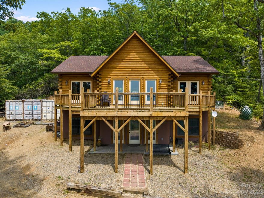 Expansive views, refreshing breezes, starry nights, 4+ open use acres of woodland with natural springs and a blissfully private custom log home make this mountain micro-farm a really special find; perfect for the modern homesteader with undeniable potential for upstyle into rustic-luxe retreat or Airbnb. The relaxed, open floor plan includes main level primary ensuite, 2 beds, vaulted great room and 2 decks with a daylight lower level for extended flex use, media, bonus/bed rooms and .5 bath. Useful closet storage, on demand hot water, well filtration, external generator plus livestock pens, powered garden chalet, raised growing beds & a 24x24 concrete pad for garage build. Access gate with camera system ensures confident enjoyment of this private paradise. Keep it rugged or luxe it up, 94 Echo Mountain View Rd is a unicorn opportunity for remarkable views and a no-HOA lifestyle less than 20 miles from AVL!