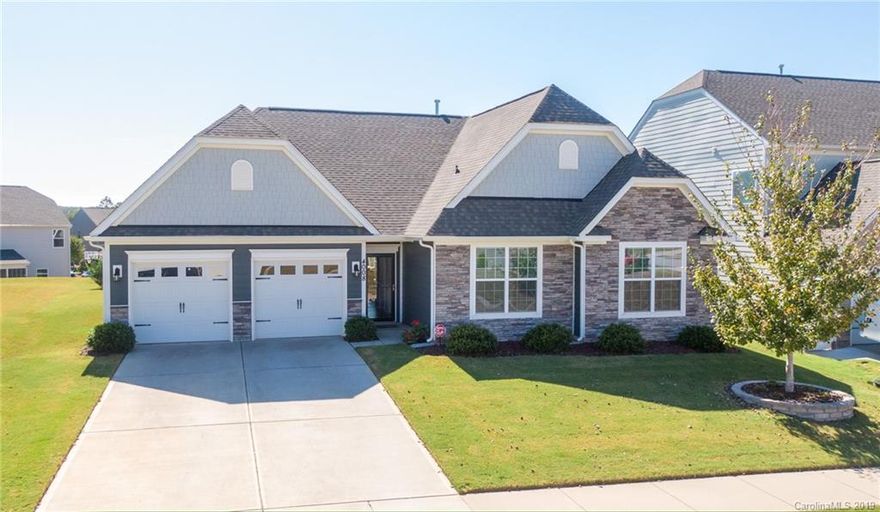 This captivating ranch home located in the desirable Walnut Creek community is good as NEW. Not only is it well maintained, but spotless inside and out! From the beautiful stone and cedar shakes on the outside of the home all the way in to the bright airy open floor-plan you will fall in love at every turn. This 3 bedroom 2.5 bath home is trimmed with crown molding and has upgraded wide wood plank flooring throughout the main living areas and owner's suite, a large open kitchen with granite counter tops and stainless steel appliances, gas hookup available for the stove, a tray ceiling in the owner's suite, his and her sinks in the master bath along with a separate shower and soaking tub. With this open floor-plan it is perfect for entertaining, which can also be moved outside onto the screened in back patio. Enjoy everything this community has to offer with a pool, clubhouse, fitness center, walking trails, ponds, ball fields, tennis courts and playgrounds.