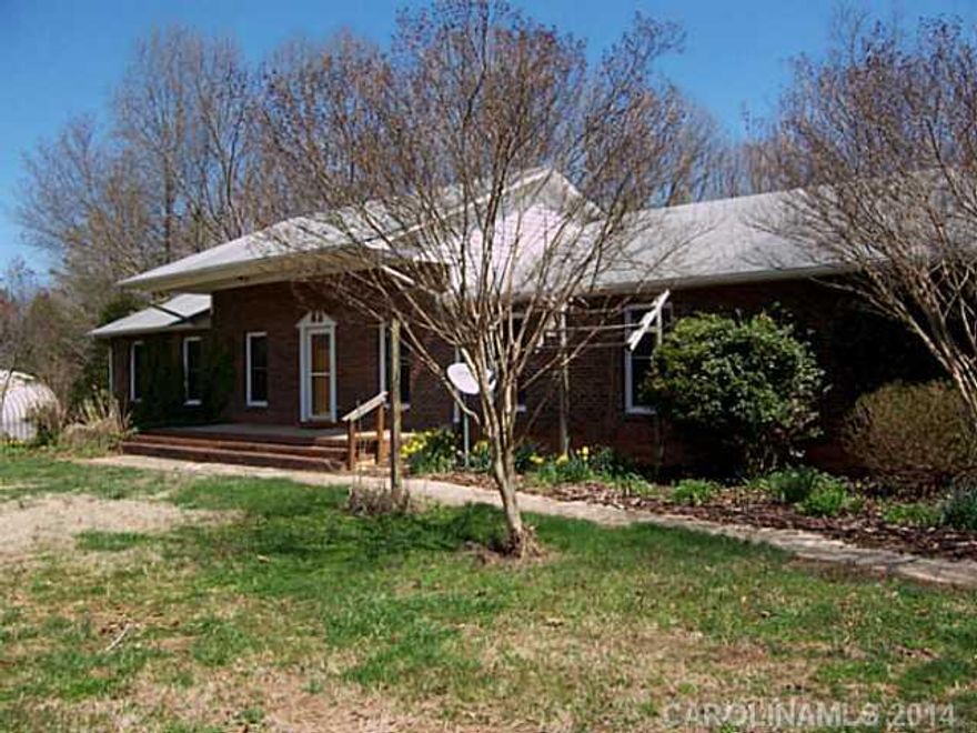 LOTS of living area in brick ranch w/bsmt. 4BR, 2BA main. LR,DR,kitchen open.Replacemt windows. HP. Spacious laundry plumbed for sink. 2 level deck w/hot tub. New paint throughout. Secondary living qtrs in bsmt w/walk-out entry, 1-2 BRs. Barn, stream rear of land, lots of woods, rocks, heritage plants. Woodstove on both levels. Potting shed. Easy commute to Charlotte