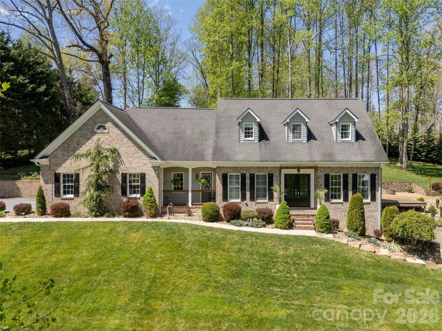 Beautifully renovated 4BR/4BA home blending modern elegance with effortless comfort. Features dual primary ensuites—one on the main level and one upstairs. Lower level offers a full in-law/guest suite with kitchen, living, dining, bonus room with walk-in closet, interior access, and exterior walk-out. Large storage/mechanical room with washer and dryer. Multiple living and entertaining spaces include breakfast area, formal dining, living room, cozy den with f/p, and a private upper-level office hidden behind bookcases. Galley-style kitchen with stainless steel appliances, granite countertops, abundant cabinetry. Crown molding, chair rail, and custom trim throughout. Spacious main-level primary suite with plantation shutters, walk-in closet, and spa-style shower with dual shower heads. Hardwood, tile, and luxury vinyl plank flooring throughout. Two additional upper-level bedrooms share a guest bath. Enjoy indoor-outdoor entertaining on 2 beautifully landscaped acres. Two-car attached garage plus a two-car detached garage/workshop. Exceptional space, flexibility, and privacy. Minutes to AdventHealth, and I-26 access.