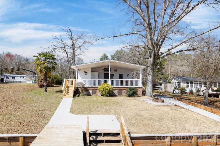 Turn key, adorable bungalow in the heart of beaver creek! This 2 bedroom 2 bathroom updated cottage is ready for
summer fun! It has been updated with new floors, new cabinets and concrete counters. There is a new full bath
and stackable washer/ dryer that's been added along with new HVAC unit, propane gas logs in the living area and
new sofa! The covered front porch is the place to be overlooking the water fun, your private dock and your private
concrete boat launch. Bring your suit and don't hesitate on this one!