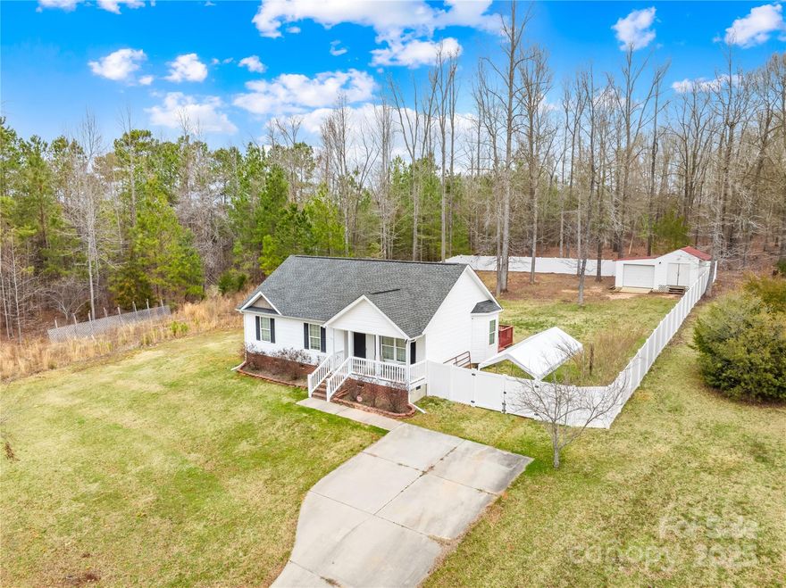 Discover the perfect blend of comfort and privacy in this charming 3-bedroom, 2-bathroom ranch home with detached 1 car garage and storage area is nestled on 1.94 acres in York, SC. This well-maintained property offers a spacious, open floor plan with vaulted ceilings, and abundant natural light. The eat-in kitchen features ample cabinetry and a cozy breakfast bar overlooking the main living area. The primary suite boasts an en-suite bathroom with dual sinks and a shower/tub combo. Additional bedrooms are generously sized with plenty of closet space. Enjoy outdoor living with a covered front porch, back deck, a privacy fenced-in backyard, and serene wooded surroundings providing ultimate privacy. The property also includes a detached storage building, perfect for tools or storage. Conveniently located near, this home offers peaceful country living with easy access to amenities. No HOA!