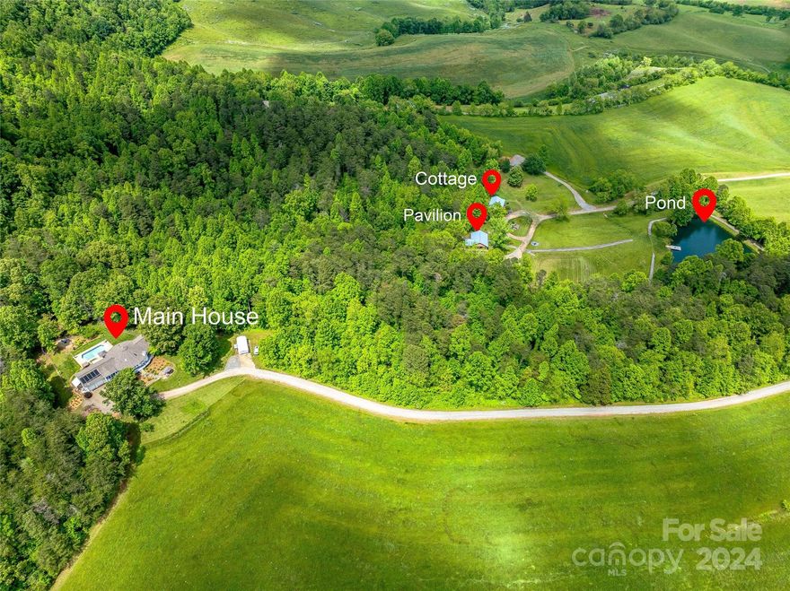 Discover your dream retreat on 102 breathtaking acres, just 20 minutes from downtown Asheville. This stunning property features rolling pastures & panoramic mountain views, creating a serene and picturesque escape.  Adjacent to hundreds of acres of conservation land. Main house with pool, guest cottage (used as Airbnb) & Pavilion (used for events).  Enhance your outdoor living with a tranquil pond, ideal for fishing or simply enjoying the peaceful ambiance set against the backdrop of natural beauty or wander through rolling pastures or maintained scenic walking/ATV trails. Whether you envision a private sanctuary, a family compound, equestrian estate, development opportunity, retreat center, farm for livestock or a unique event venue, this versatile estate offers endless possibilities. Embrace the best of both worlds with rural tranquility & easy access to Asheville’s vibrant culture, dining, and entertainment. Don’t miss the opportunity to own this extraordinary piece of paradise!