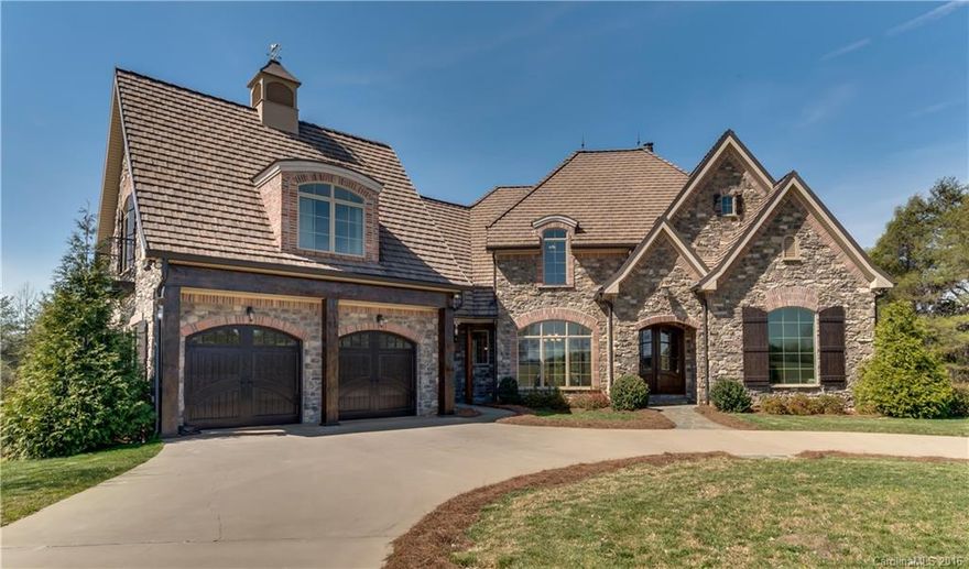 Think French Country Elegance – Stunning 4B/4.5BA French country home set on 23 acres of rolling pastures in The Farms at Mill Spring equestrian community. Luxurious touches abound from stone exterior with brick accents to soaring ceilings and warm walnut floors. 3 Mendota FP's add comfort on winter nights.  Custom cabinetry and high-end touches throughout the home create a unique and comfortable living environment.  Enjoy morning coffee on your private flagstone balcony. Just minutes to TIEC.