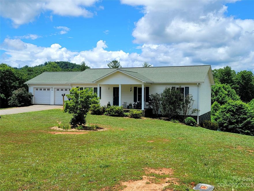 Wonderful 3BR/2BA home situated on nearly an acre in a quiet neighborhood surrounded by the stunning South Mountains!  Less than 6 miles to Downtown Morganton, 3.5 miles to I-40, close to schools and gorgeous hiking/horseback riding trails in South Mountain State Park.  Spacious open concept living features beautiful hardwood floors, dining area and kitchen with maple cabinetry, stainless appliances and oversize island perfect for gathering.  Cozy, covered back deck overlooks beautiful mountain views, and fully fenced back yard.  Primary suite accommodates king-sized furniture, and features an ensuite bath with shower/tub.  Full unfinished basement with interior/exterior access, and is partitioned with flex space, laundry and future bath already rough plumbed and a workshop/utility room with double doors opening to exterior.  Attached 2-car garage with automatic door openers. REMC electric, Burke County water, Spectrum cable and internet, AT&T & Republic Services for waste available.