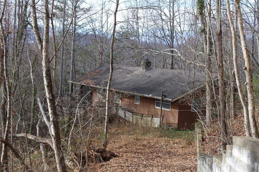 Diamond in the rough. This 2-bedroom 2 bath home needs a good bit of work, but it could be brought back to its once prominence. The home feature vaulted ceilings, huge windows, a wood fireplace, and a cute kitchen with a breakfast bar. The two bedrooms on the main level are good sized, both with good closet space, and they share a bath. The lower level once was a standalone bedroom and has a full bath. It did flood and needs to be completely remodeled. The home needs extensive repairs. There is a foundation wall that needs attention, the roof appears to be leaking and all new decks. If you are ready for a project this could be the home for you.