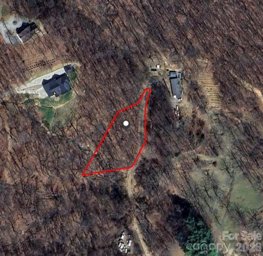 Welcome to peace and serenity. This lot offers all of that. No HOA. The lot is located near the end of the dirt road on the left. Electric is available, well, and septic is needed. Come check out this lot and bring your plans and builder. There is a small stream running through the lot for running water access. Close proximity to Lake Junaluska and Waynesville greenway park.