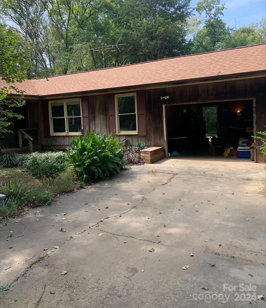 Great Fixer Upper or Investment opportunity on 6 acres of land.  The house is in a great country setting with endless opportunities for your future plans. House with 3 bedrooms, 2 bathrooms, and attached garage. There is a room addition without a closet that makes for a great office, or you can convert back into a larger living area. 
The yard is mature with beautiful plants, fruit trees and fixer upper outbuilding. The roof was recently replaced, and county has verified that the land can be subdivided.
BEING SOLD AS IS