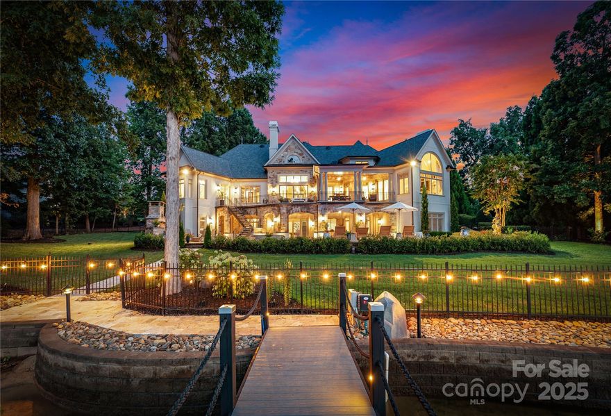 Impressive lakefront home: One-story living w/ an elevator to access the fully finished walk-out lower lake level!
This home was artfully transformed into a dream retreat, where every room offers breathtaking lake views. Every detail speaks of opulence: intricate molding, detailed ceilings, custom lighting, 2 sumptuous primary suites on the 1st floor, soaring vaulted great room, stunning dining room, gorgeous lakeside family room, an exquisite study & the newly redesigned kitchen is a culinary haven. The lake level is an entertainer’s paradise, w/ a custom wine bar, billiard room, golf simulation room, home gym, 2 guest suites, a flex room or 5th bedrm. Outside, expansive terraces w/built-in grill, cozy fireplace, saltwater pool & spa, new dock equipped w/ 2 jet ski lifts & 10k-lb boat hoist. With 220' of shoreline, this gem offers endless sunset views. Brand New Control4 smart home w/Luma video surveillance, controls HVAC, music, lights & remotely controlled garage doors.