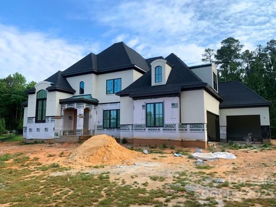 Spectacular French Country NEW home for a Luxury lifestyle & entertainment in a sought-after Waxhaw-gated community on a large wooded flat lot of 1.14 ACRES w/pond a side view. SAVE ALL THE HASSELS WITH RENOVATING. Onsite finished white oak hardwood floors -NO CARPET. This spacious 5 bedroom, 4-1/2 bath loaded w/upgrades has a wonderful open floor plan design. Grand two-story foyer w/wet bar area & easy access from dining, family & kitchen area. Get pampered w/master suite that includes, a walk-in closet, & a spa-like bath.  Kitchen w/tall & SOFT TOUCH cabinets & large middle island. Sculry/dirty kitchen has an extra sink, dishwasher, cabinets & shelves to organize the grocery & hide dirty dishes. A dramatic grand study. 3 large beds suit w/high ceilings & walk-in closets. 5th bed/bonus w/walk-in closet. 2nd laundry upstairs. Family room w/cabinets, shelves, cast stone fireplace, ceiling details, 2 sliding doors to back covered patio w/fireplace. Mud area w/drop zone & laundry.