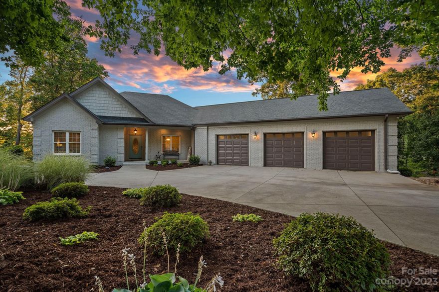 Your lakefront oasis awaits you! Welcome to 252 Greenbay, located in a private, quiet cove in Mooresville. Hop on your boat or paddleboard/kayak, and cruise into big open water in just a couple of minutes. From lovely exterior landscaping and lighting, a fire pit, and ample porches to relax on, to gorgeous finishes on the interior, this is a home you won't want to leave! Open floor plan featuring a great room with vaulted ceilings, fireplace, and views of Lake Norman. Enjoy open concept entertaining, with a kitchen with breakfast bar and island. Primary bedroom on main level boasts lake views and spa-like bathroom with walk-in shower, garden tub, and separate vanities. Enter the basement and spend time playing games, or enjoying the covered porch and pergola-covered patio. The basement is even equipped with a full kitchen! This is truly a lakefront getaway that you don't want to miss!