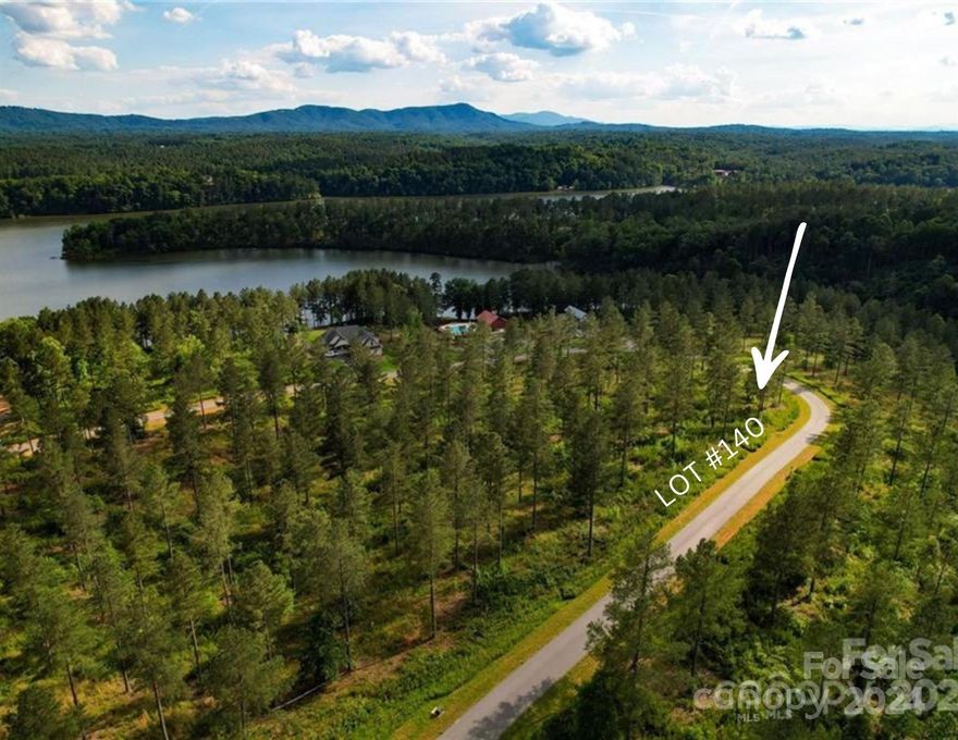 Large road frontage of 518ft on 1.65 Acres on a nice Lot in this gated subdivision " The Waterfront Club." This vacant property is right near the community amenities which include a pool, lake access, recreation area, fire pit, BBQ grills, community dock and mountain views. Also located in the subdivision are miles of walking trails and a lakeside cabana and a sandy beach area. Lake Rhodhiss is ideal for fishing, boating, water skiing, wakeboarding, paddle boarding, swimming, kayaking, canoeing, or sitting peacefully on the community dock.