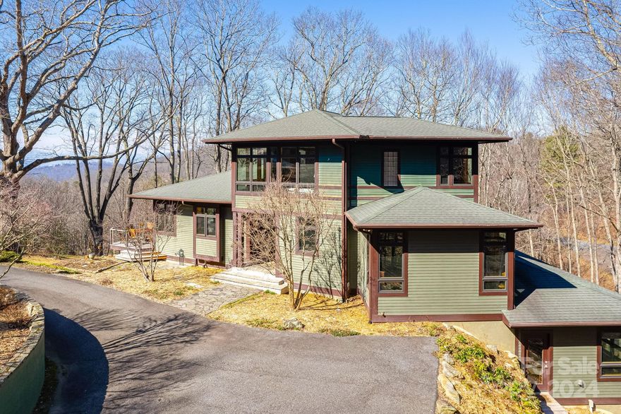 This one of a kind modern mountain home is seamlessly blended into the surrounding natural landscape of Elk Mountain. "Nestled In" was custom designed with comfort and also style in mind. Visitors are greeted by the spacious great room filled with natural light, as well as a cozy fireplace and custom kitchen. Enjoy long range year round mountain views from the adjoining deck overlooking the property. Upstairs you'll find the private primary suite with French doors, two closets, and luxurious soaking tub and spacious slate shower. With 4 bedrooms and 3 full bathrooms, this unique home provides amble space for guests to enjoy as well as areas for an office space and home gym. Watch your favorite movies in the home theatre or sneak up to the private sleeping porch for coffee and conversation. An elevator runs centrally through the home for easy assess to any level. Truly a home for all seasons on 2.62 acres with thoughtful landscaping, a meandering creek, and native plantings to enjoy.