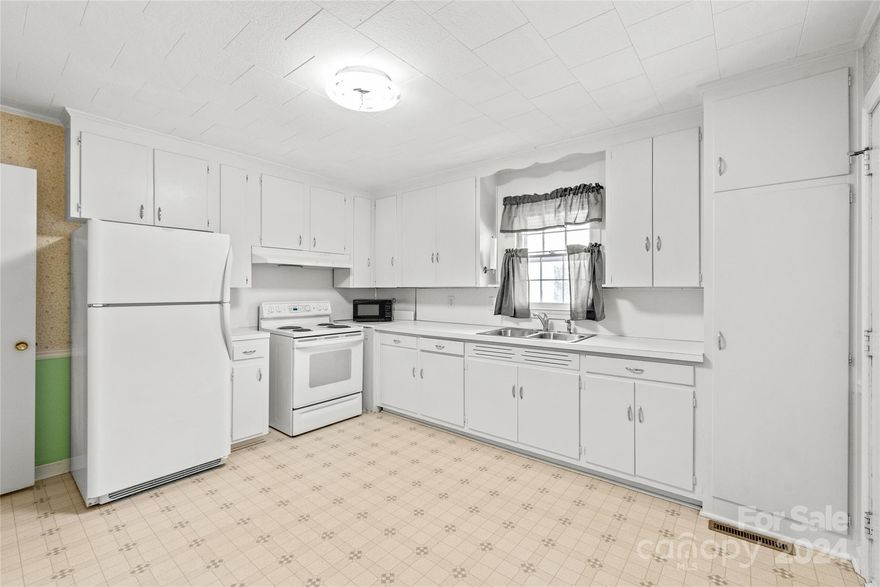 Cute Bungalow original mill house with eat-in kitchen, large oversized (.39 acre), large laundry storage room (143 sq. ft) off living area, refrigerator, stove included, large 24 x 24 garage with back additional storage room - two bays.  Under the carpeted area, at the vents, you can see the hardwoods under the carpet.  Original Mill House close to the historical village of Fort Mill and Springs Mills.  The historical downtown and new Amphitheathre at Walter Y Elisha Park in within walking distance.  Fort Mill is known for their highly rated school system, preservation of history, and their downtown area has shopping and dining in historically preserved buildings.  The lot is grand and through York County/Fort Mill permitting office, you may seek to see if adding on to the home is beneficial.