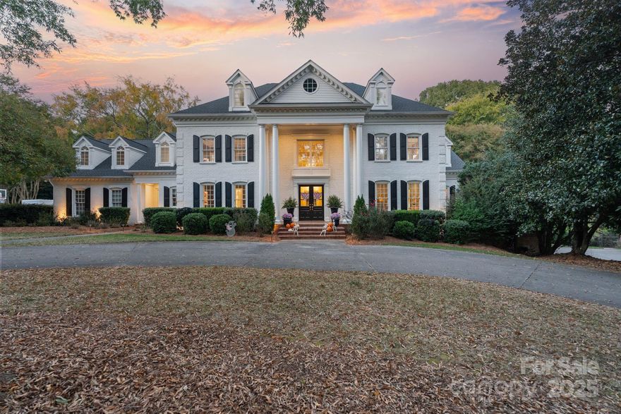 Stunning home custom built by Simonini in the gated enclave of Hampton Manor offers a private, one acre lot with heated salt water pool, spa and outdoor kitchen, it’s been exquisitely updated in the last 5 years and is designed for elevated everyday living. Enjoy soaring ceilings in the redesigned keeping room with new fireplace surround and built-ins, a dedicated home office, plus a main level primary suite with access to your covered porch. A striking feature is the kitchen including Wolf/SubZero appliances, three dishwashers, custom cabinetry, two pantry spaces, scullery plus butler's pantry and sunlit breakfast area. Upstairs: bedrooms 2 and 3 each feature an ensuite bath and walk in closet, while bedrooms 4 and 5 share a spacious dual vanity bath.  A sunny bonus room includes new plank flooring and new window. A finshed third floor rec room is ideal for theater, exercise, play space or storage. New Roof (2023), sealed crawl, 3 car side load garage with abundant storage. Hampton Manor is a quiet, tree lined street tucked into a prestigous pocket off the convenient Carmel Rd corridor. Discover the one that checks all the boxes: Location. Luxury. Privacy. Quality and a NEW PRICE.