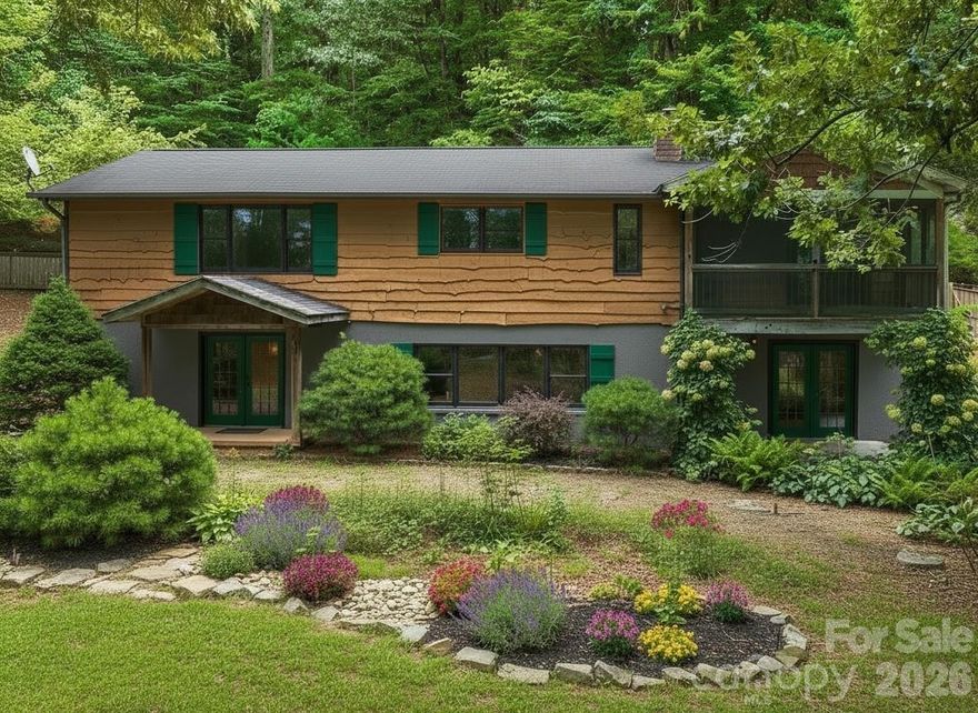 Back on market through no fault of the seller.  A peaceful retreat offering space, privacy, and flexibility. This 4-bedroom, 4-bath home with bonus room spans just under 3,200 sq ft on nearly an acre of wooded land. Surrounded by mature azaleas, ferns, and seasonal blooms with winter mountain views and vibrant fall color. A brand new whole-house HVAC system was installed in July 2025. One side has operated as a successful short-term rental; the lower level—with private entrance and dedicated stairs—offers great potential as a guest suite, in-law quarters, or long-term rental. Both spaces have separate entrances and stair access. Additional features include a screened-in porch, outdoor shed with 220-amp power, and a yard dotted with blueberry bushes, plum and peach trees. Located just 5 minutes from Biltmore Park’s dining, shops, galleries, and movie theatre, and only 15 minutes to both downtown Asheville and the airport. A rare opportunity to enjoy space, income potential, and an unbeatable setting. Some photos are virtually staged and/or enhanced.