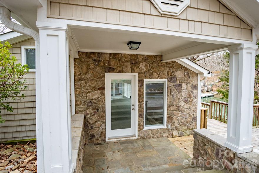 You will love the privacy on this wooded .97 acre waterfront lot.  This rare gem offers beautiful open water views with the protection of a lovely cove.  Home was built in 1950 but has been beautifully renovated with updated bathrooms and kitchen.  Family Room has a rock fireplace with gas logs adjacent to a large open sunroom area
that offers ample space for entertaining.  Lots of windows throughout give you that natural light that is a great
asset.  The larger screened porch adds a whole new element to this property.  As if that wasn't enough, these is 
a large lot above the property that would accommodate a multitude of uses.  There is a small building with power, 
it is all fenced with space for an RV, etc.  No HOA restrictions to hinder use.  
Close proximity to Charlotte & Airport.