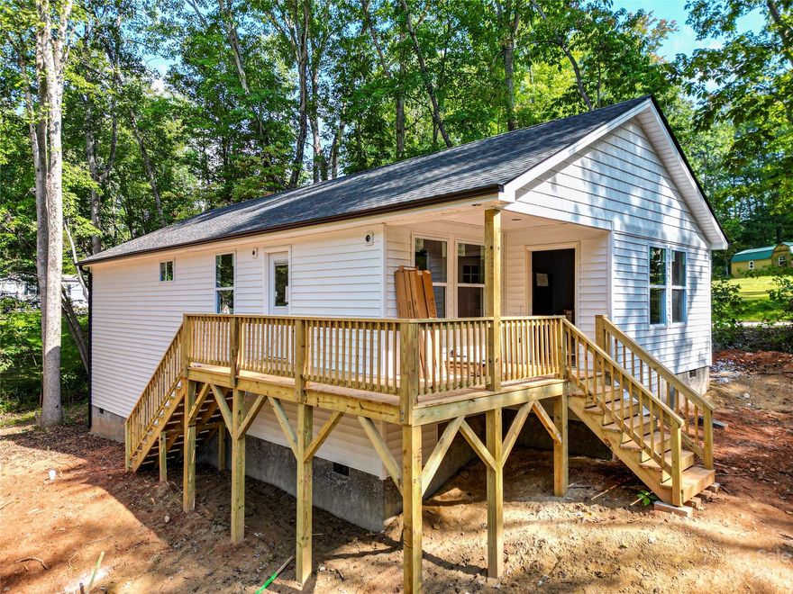 Complete and Move in Ready! Brand new construction convenient to everything Candler has to offer. Open floor plan bathed with warm natural light is perfect for entertaining. Primary bedroom boasts a large walk-in closet and primary bath with dual vanity and custom tile shower. Luxury vinyl plank flooring, fabulous kitchen with stainless steel appliances, granite counters, spacious all-plywood soft close cabinets, under cabinet lighting, and the perfect kitchen island. Neutral colors make decorating a breeze. Large decks are a spectacular place to enjoy that clean mountain air. Well-priced, move-in ready and waiting to hold all of your fond memories or become your next charming retreat or sought after investment property. Finished interior pictures are shown as an example. Finishes are consistent, but may vary slightly depending on availability. Tax value based on previous vacant land and does not represent current improvements.