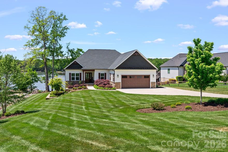 Welcome to this custom-built waterfront retreat in Hidden Hills community on High Rock Lake where lake living truly shines. This beautifully designed 3 bedroom, 2 bath home features an open-concept layout with stunning water views throughout. The chef's kitchen features a large island, a spacious pantry, & flows seamlessly into the main living area-perfect for entertaining or relaxing by the fireplace. Step out onto the deck, which offers both a covered space for lounging & an uncovered area ideal for grilling. Enjoy the spacious primary suite with a large bathroom and an oversized closet. This home also features a cozy office space, a dedicated laundry room and two gues rooms with custom closets. Downstairs, the partially finished lower level provides a blank canvas for the buyer to create the ultimate lake-level entertaining area! Step outside to a large covered patio, then stroll down to your fire pit and private dock to fully embrace waterfront living.