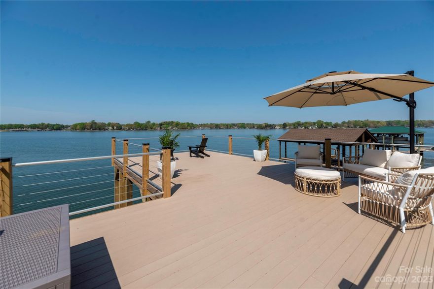 Welcome to this one of a kind home on Lake Norman! You are ushered in with beautiful landscaping. A long drive that ends in a magnificent view of the lake. Follow the path along to the front where double doors greet you. Inside you will find a move-in ready, bright, updated and fresh home full of windows and lake views. The kitchen boasts a large island, quartz counter tops and backsplash, gorgeous lighting and stainless steel appliances. 4 bedrooms and 3 full baths, a main level living area & lower level living area, 2 fireplaces & gorgeous, stunning details everywhere. There's room for entertaining inside and out! The patio doors are double sliders, completely opening to seamlessly unite you to the deck, patios, grassy yard, pergola, firepit & 2-level boat dock! Deep water surround this amazing dock with a huge upper sun deck, lower deck area and large covered boat storage. Bring your boat and enjoy this beautiful home all season long! The sunsets are breathtaking and incredible!!