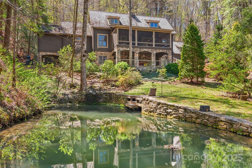 Tucked away behind a private gate, this breathtaking 20+ acre estate offers the perfect blend of luxury and nature. The 3-stall barn and pasture are ready for horse enthusiasts or someone with llamas, goats, and other four-legged companions. The 4BR/4.5BA main home is crafted with exceptional detail—designed to capture beautiful natural light with a dream kitchen, high-end appliances, custom cabinetry, and an oversized island. A breezeway connects to a 3-car garage with a spacious studio above, ideal for a creative space or workshop. The finished basement offers potential for separate living quarters, perfect for multi-generational living or guests. Relax by the outdoor fireplace, tend vibrant gardens, explore peaceful hiking trails, or unwind beside the koi pond. A large detached garage includes a 1,400+ sf guest house with 1BR/1.5BA and expansive rec room. A rare opportunity to live the lifestyle you've always imagined — with beauty, privacy, and timeless craftsmanship at every turn.