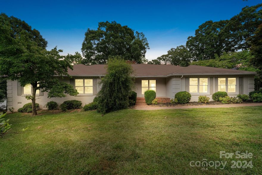 Imagine a beautiful modern farmhouse-style home nestled on the serene waterfront of Lake Wylie, SC, perfectly situated on 1.48 acres of private land. This picturesque property boasts stunning lake views from both the main and basement levels, providing a tranquil retreat and a visual feast for the eyes. Your modern farmhouse is adorned with classic white full brick exterior and grey wooden shutters and newly finished hardwood floors throughout the main level. A charming wraparound rear porch invites you to sit and enjoy the peaceful surroundings. The expansive backyard slopes gently down to the water, where a private dock extends out into the lake, perfect for boating, fishing, or simply relaxing by the water's edge.  Boaters the water here is roughly 40 feet deep by the dock.  Lots of privacy and plenty of more opportunity to make this home a magnificent retreat.