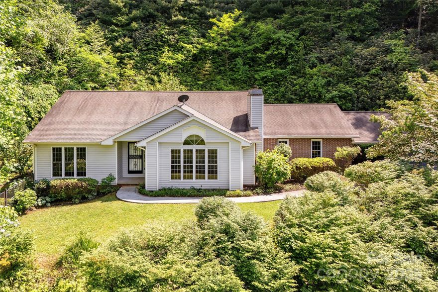 Charming One-Level Haven - Discover the perfect blend of tranquility and convenience in this 3 BR, 2 BA home situated on a lovely lot overlooking one of Brevard's most desirable neighborhoods. There is a separate, add'l lot that also conveys with the home.  This thoughtfully designed home offers comfortable one-level living, making it ideal for all lifestyles.  Walk to the renowned Brevard Music Center and Bracken Mountain Preserve, w nearby hiking and biking trails.  Just minutes away from vibrant local attractions and downtown Brevard's dining and shopping.  Community amenities incl outdoor pool, clubhouse, trash pick-up, plus more.  With its generous living spaces, fireplace, and a serene outdoor setting, incl a fenced-in backyard and patio for fun with four-legged friends, this property is an opportunity that promises a lifestyle of comfort and leisure.  New Luxury Vinyl Plank floors in addition to existing hardwood.  Primary BA features handicap accessible shower.