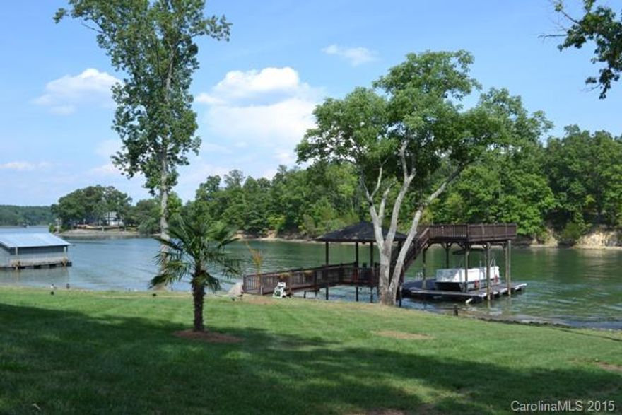 Absolutely stunning home w/spectacular waterfront views! This will be a pleasure to show. Owner has made many changes & updates. Gorgeous hardwood, ceramic tile & carpet throughout. Chef's granite kitchen w/work island, stainless appliances. Formal areas, great room with fireplace. Basement has a full kitchen, bath, media room and den. 3rd level houses a bonus room, bedroom and full bath. HUGE screen porch overlooking the lake, deep water dock. Tons of storage. Beautiful landscaping, full irrig.