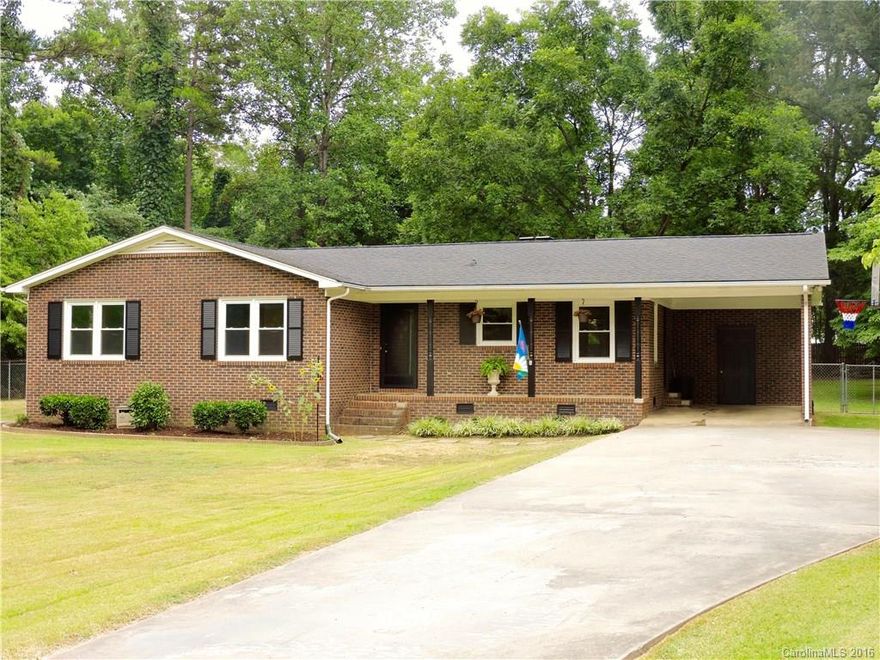 Sitting on over 3/4 acre, this well-maintained ranch w/3 bedrooms & 2 full baths is ready to move into.  Surrounded by trees w/fruit trees-blueberry, peach, pear, & pecan be ready to enjoy a relaxing morning or evening in the back screened-in deck or rocking chair porch.  Long driveway for ample parking w/carport.  Washer/Dryer in utility room off carport.  Windows 2012, prof. installed gutter guards, sits next to wooded lot, has privacy back fence, raised garden beds, ceiling fans, & hardwoods.