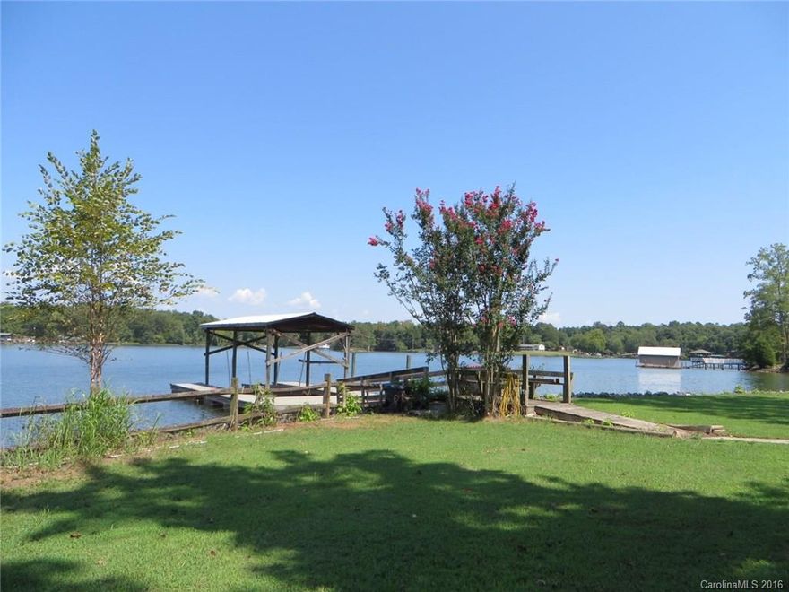 Turn this into your dream WATERFRONT home or a fun weekend  retreat!  Charming setting among the trees opens up to wide 180o views of Lake Wylie. Easy stroll to the floating dock with boat house and lift. Over 235 feet of prime shore line with attractive stone retaining wall. Huge, level yard offers loads of room for play and gatherings. Rustic cabin on property sold as is.