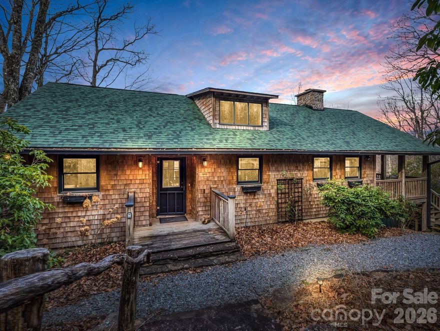 Escape to your mountain retreat with panoramic views of the French Broad River Valley and the Blue Ridge Mountains!  This charming hoome offers the perfect blend of comfort and nature, with breathtaking sunset views and four seasons of beauty.  Enjoy the warmth of the stone fireplace in the cozy living room, hardwood floors throughout, newer roof in 2022, and an open floor plan.  This property is not only a tranquil getaway but also a great investment opportunity and is currently a short-term-rental.  Located approx 5 miles from downtown Brevard, you'll have easy access to dining, shopping, and cultural events, while being only moments away from hiking trails and the stunning Pisgah National Forest.