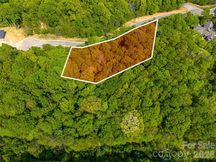 Beautiful, wooded, and private lot located in the highly desirable gated community of Poplar Ridge—one of Asheville’s premier mountain communities. Surrounded by mature trees and the natural beauty of the Blue Ridge Mountains, the property provides a peaceful, secluded setting. With elevations ranging from 2,300 to 3,300 feet, the community provides a stunning natural backdrop and a peaceful mountain atmosphere, all while being just a short drive from the vibrant city of Asheville. Enjoy convenient access to shopping, dining, schools, and major roadways without sacrificing the quiet seclusion of mountain living. Adding to its appeal, a completed geotechnical and soil evaluation brings you one step closer to building your dream home—saving you time and offering peace of mind as you plan your future residence.
