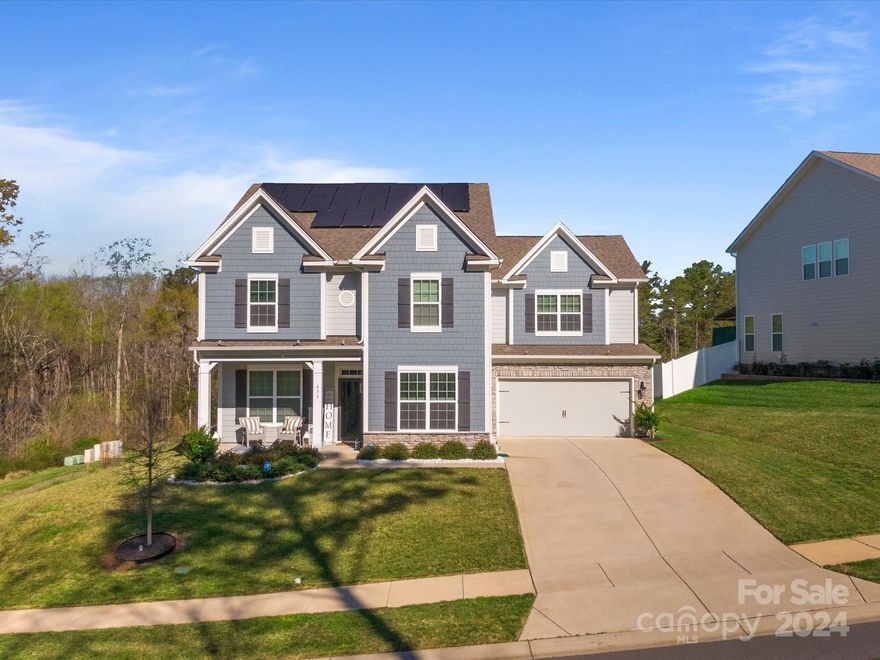 ABSOLUTELY STUNNING 5 bed, 4.5 bath home in Lake Wylie!! Better than new and immaculately maintained!! This home has it ALL - solar panels w/ a battery system, a fully irrigated yard, landscape lighting, epoxy garage floor, Deako smart switches in the entire home, wiring for an electric car charger, a beautiful gourmet kitchen with white cabinets, quartz counters, double ovens and a gas cooktop, a tankless water heater, wide plank rev-wood flooring on the entire main level, and a dedicated office with French doors on the main level. The private 98-ft wide lot has common space to the side and a beautiful view of woods behind. The spacious floorplan features a guest suite on the main level, and four additional bedrooms w/ three bathrooms upstairs. The primary suite features a trey ceiling, a beautiful tile shower, double sinks and a huge walk-in closet. The spacious laundry room is upstairs and the HUGE bonus room is perfect for a theatre room and play area. Low taxes and Clover Schools!
