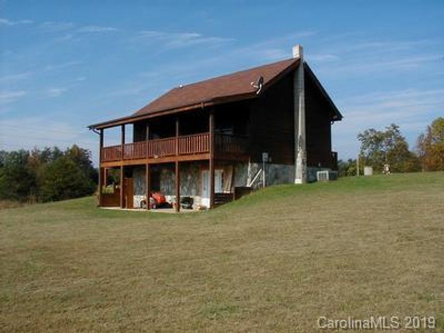 Log home (built by Larry Birchfield) with 3 levels.  Main level includes 780+/-  square feet with 1 bedroom, bath, kitchen and great room.  Lower level includes 780 +/- square feet (about 50% complete) with bedroom or office space, den and other space that can be completed.  Lower level is also plumbed for a bathroom and has its own entrance.  The upper level is the Master bedroom and bath area with 240+/- square feet.  The Master bath is open to the Master bedroom.    This home has beautiful long range mountain views.    Directions:  From Marion (exit #86 from I-40) Go south on Hwy 226.  Turn left on Pinnacle Church Rd., House is on left with sign in yard.