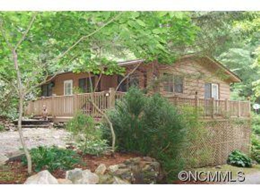 Looking to get back to nature? This is your dream home. Trout Streams, endless hiking trails at the foot of MT. Mitchell chain. Listen to Buck Creek cascading outside your windows. Updated wood floors, tons of deck space, circular drive, 3 bedrooms, 2 baths with a large living area on the main floor. Unfinished storage space on the lower level with a wood burning stove for those chilly nights. A 1 bedroom cottage also included!