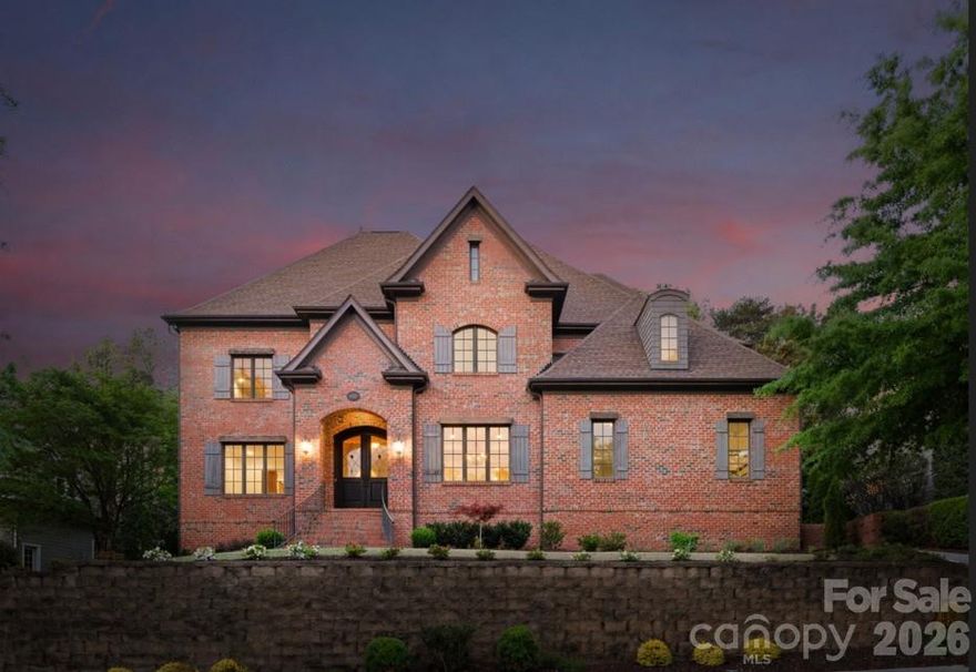 Welcome to 16849 Ashton Oaks Drive—an exceptional custom-built, private, full-brick two-story estate offering 5 bedrooms, 5 bathrooms, and 5,201 square feet of refined living in the gated Ashton Oaks community. Ideally situated, the home is just a short walk to The Palisades Country Club, where resort-style amenities include the Jack Nicklaus–designed golf course, driving range, tennis courts, resort-style pool, dining, and a state-of-the-art fitness center. The thoughtfully curated main level features eight interconnected living spaces designed for both everyday comfort and elegant entertaining. Highlights include a private guest suite—ideal for multigenerational living or extended stays—a dedicated study perfect for remote work, and a luminous sunroom with dual entry and French doors, creating a peaceful retreat for quiet reflection. A classic formal dining room sets the stage for memorable gatherings, while the main living area is anchored by an elegant gas fireplace framed by custom built-in cabinetry, soaring ceilings and abundant natural light. At the heart of the home, the gourmet kitchen is both functional and sophisticated, featuring custom cabinetry, a Thermador 6-burner professional cooktop, and a full suite of premium appliances. An oversized granite island with prep sink serves as a central gathering point, seamlessly connecting to the main living areas and sunlit breakfast space with lovely views. Outdoor living is equally impressive, with a resort-style covered rear porch—perfect for grilling, entertaining, or simply enjoying the serene, private, wooded backyard (Owners have pool renderings and a had several quotes done). The main level is completed by a beautifully appointed laundry room featuring a full cabinet suite, granite countertops, and a stainless steel deep-bowl sink. The upper level serves as a private retreat, accessed by two separate staircases, and offers four spacious bedrooms, three well-appointed bathrooms ( 1 is a Jack-and-Jill bath with double vanity), a secondary home office and a versatile bonus room with custom cabinetry and floor-to-ceiling storage provides exceptional flexibility. The elegant primary suite is a true sanctuary, featuring expansive natural light, a custom tray ceiling, designer lighting, dual walk-in closets, and a distinctive barrel hallway leading to the spa-inspired bath with a seamless tiled shower and Roman soaking tub. Recent updates completed in April 2026 by the sellers include refinished Brazilian cherry hardwood floors on both levels, new Shaw carpeting in the bedrooms, fresh interior paint throughout (including ceilings, walls, trim, and closets), and updated lighting fixtures. The expansive three-car garage has been refreshed with a newly painted interior and a custom epoxy floor. The covered rear porch has also been professionally cleaned and stained, enhancing its natural beauty. Owners also had several local pool companies come out and consult. See pool renderings in photos. Enjoy close proximity to Lake Wylie, scenic walking trails, and the exceptional lifestyle amenities that define The Palisades. Schedule your private tour today.