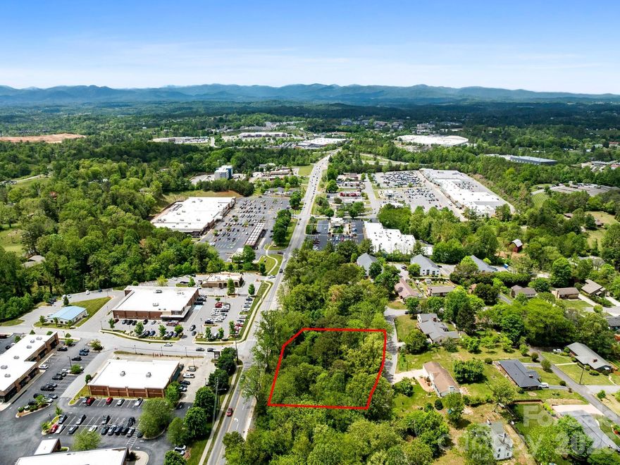 Tucked away just off Main Street in the heart of Weaverville, this rare 0.84-acre residential lot offers a unique opportunity to build in one of Western North Carolina’s most desirable small towns. Zoned R-1 and held in the same family for over a century, the property remains untouched—providing a blank canvas for your custom home surrounded by mature trees and natural beauty. Located in a quaint, established neighborhood, the setting blends privacy with convenience, offering easy walking access to local shops, restaurants, and everyday amenities, while still allowing for a peaceful, wooded retreat. Downtown Weaverville is known for its welcoming small-town charm, vibrant arts scene, boutique shopping, and popular dining, along with year-round community events that create a lively yet relaxed atmosphere just minutes from Asheville. The property also offers excellent regional connectivity, located approximately 2 miles from Interstate 26, 10 miles from Interstate 240, and with quick access to US Highway 19/23, making travel throughout the Asheville MSA and beyond both convenient and efficient. With close proximity to outdoor recreation, including hiking, biking, and scenic mountain landscapes, this legacy property presents a rare chance to create a primary residence or mountain getaway in a highly sought-after location.