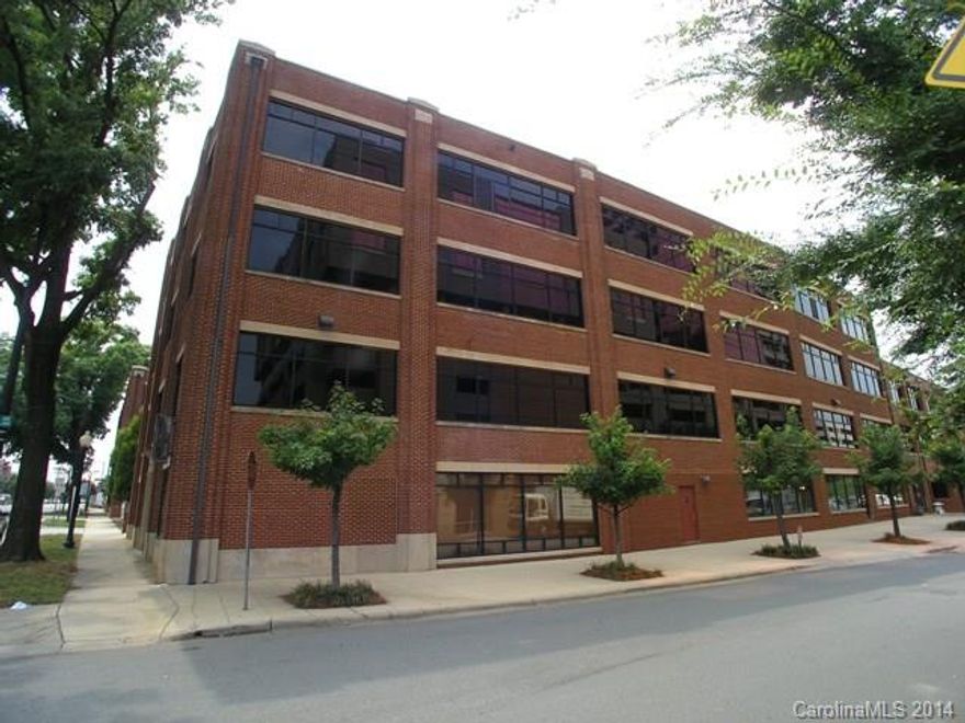 Close to light rail in South End. Third floor unit. Granite counters, large open loft with hardwoods throughout. Exposed brick wall at windows with custom privacy shades. Updated bathroom w/dual vanities and shower enclosure. Dramatic high ceilings. Each unit has separate, dedicated storage, as well as community bulk storage. Community grill and patio area, covered parking, security cameras, and more!