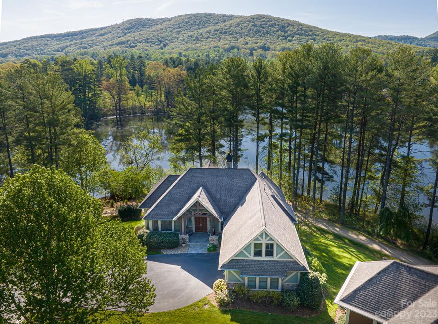 Sited in gated Cedar Rock ON THE lake, this quintessential Biltmore Lake living.The home is framed by an inviting front porch that welcomes you into the living room with a gas stone fireplace, flowing to the dining area and kitchen with KitchenAid appliances. Take in the tranquil setting from the beautiful deck and covered porch overlooking the lake and lakeside loop trail. A main level primary features an oversized bathroom with double vanities, shower and soaking tub. The lower level hosts three bedrooms, two bathrooms and family room with a gas fireplace and custom wet bar incredible spaces for entertaining. this well-maintained craftsman home is a tranquil place to reside after days on the lake, walking or biking the trails, or playing basketball or tennis on the lakeside courts. EASY lock and leave! Grounds are maintained by HOA. This is a wonderful place to call home for those who enjoy a peaceful and active lifestyle in a beautiful natural setting.